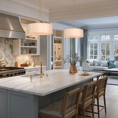 a large kitchen with an island in the middle and two chairs at the counter top