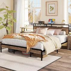 a bed sitting on top of a wooden floor next to a white rug and window