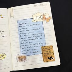 an open notebook with writing on it and some paper stickers attached to the pages