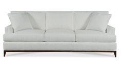 a white couch sitting on top of a wooden frame