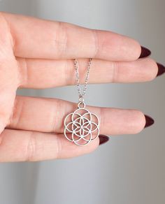 "Seed of Life - Sacred Geometry Necklace  This beautiful pendant is approx 2 x 2cm and is double sided. Choose your necklace size, 18\" Stainless Steel chain or a black waxed cotton cord at 13\", 18\" or 24\". The Seed of Life is a universal symbol of creation, found at the heart of an ancient symbol called the Flower of Life. It has been around for centuries and has captured the minds and imaginations of holy men, philosophers, and even scientists. The basis of the Seed of Life is the circle, a Adjustable Silver Necklace For Gift, Silver Hypoallergenic Flower Pendant Necklace, Hypoallergenic Silver Flower Pendant Necklace, Hypoallergenic Silver Necklace With Flower Pendant, Hypoallergenic Metal Pendant Necklace, Adjustable Silver Chain Charm Necklaces, Spiritual Silver Charm Necklace In Stainless Steel, Spiritual Silver Charm Necklaces In Stainless Steel, Silver Spiritual Charm Necklaces In Stainless Steel