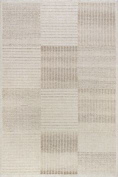 an area rug with squares and lines on the floor in neutral colors, including beige