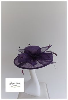 Striking angle tilt hatinator in purple claret sinamay.  A large imposing bow  takes centre stage on  the crown to  add a 'ladies that promenade' Downton Abbey image to this classic headpiece.  A cluster of purple, plumb rhondelle beads take centre stage, whilst Diamond cut coq feathers add movement as they sway in the breeze.  Sits on a headband .  This item has sold, however, similar pieces can be made in a variety of colours.  Please ask for details.  As every piece is handmade, some differen Adjustable Purple Top Hat With Curved Brim, Purple Hat With Short Brim For Royal Ascot, Purple Hats For Royal Ascot Races, Purple Short Brim Hat For Royal Ascot, Purple Curved Brim Mini Hat For Kentucky Derby, Purple Mini Hat With Curved Brim For Kentucky Derby, Elegant Purple Top Hat With Curved Brim, Purple Fitted Wide Brim Costume Hat, Purple Fitted Top Hat With Curved Brim