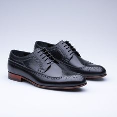 Black Flors Classic Shoes Black Formal Lace-up Shoes With Brogue Detailing, Elegant Black Calf Leather Lace-up Shoes, Black Wingtip Lace-up Formal Shoes, Black Brogue Derby Shoes For Formal Occasions, Elegant Black Wingtip Lace-up Shoes, Elegant Derby Shoes With Cap Toe And Rubber Sole, Elegant Closed Toe Lace-up Shoes For Derby, Formal Lace-up Shoes With Textured Sole In Calf Leather, Formal Lace-up Shoes With Calf Leather And Leather Lining