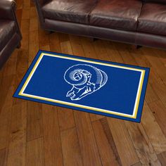 3' x 5' Los Angeles Rams Retro Logo Blue Rectangle Area Rug. Show off your team pride in a big way! 3'x5' ultra plush area rugs won't leave any doubt about who you will be rooting for on game day! Non-skid backing keeps rug in place. Made of 32 ounce nylon carpet, which feels great on your feet. Chromojet printed in vibrant true team colors. Cleaning is a breeze, just vacuum regularly. Great for g Nylon Carpet, Game Rooms, Plush Area Rugs, Kids Gear, Man Caves, Plush Rug, Backyard Party, Los Angeles Rams, Retro Logo