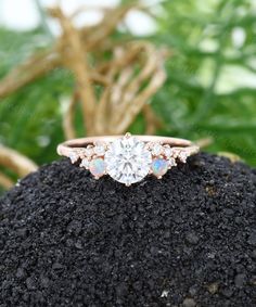 an engagement ring sitting on top of a rock