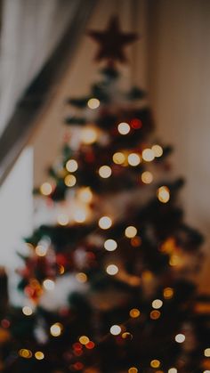 a christmas tree with lights in the background