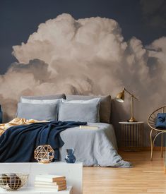 a bedroom with a large cloud painted on the wall and bed in the foreground