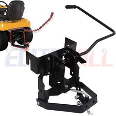 a yellow lawn mower sitting on top of a metal stand next to a black object