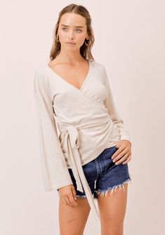 This bohemian chic long bell sleeve wrap-around top is so soft & flattering, you’ll never want to take it off. With... Knit Wrap Top, Wrap Front Top, Taupe Sweater, Neutral Sweaters, Winter Outfits Aesthetic, Stitch Clothes, Boho Skirt, Cropped Cardigan Sweater, Chic Bohemian