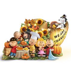 a group of people standing around a thanksgiving display