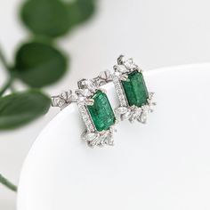 These beautiful stud earrings feature a pair of 2.58 carat weight Emerald gemstones with natural earth mined diamonds set in solid 14K gold. These Emerald studs make a lovely May birthstone gift for your loved ones! These earrings are made with solid 14k Gold and natural earth mined SI / G-H Diamonds. As listed, these earrings are ready to ship. If you're interested in purchasing this setting with a different center stone please message us! Emerald Cut Diamond Earrings With Gemstone, Fine Jewelry Gemstone Baguette Cut Earrings, Fine Jewelry Baguette Cut Gemstone Earrings, Anniversary Baguette Cut Gemstone Earrings, Emerald Cut Stud Earrings, Emerald Studs, Emerald Stud Earrings, Designer Silver Jewellery, Blue Stud Earrings