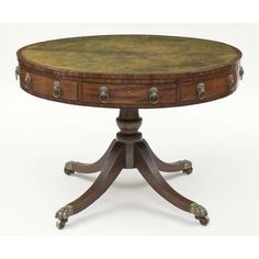 a round wooden table with two drawers on one end and three legs on the other