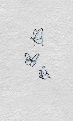 three butterflies flying in the air on a white surface with watercolor paint and black ink