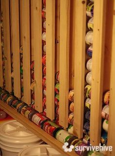 an image of a rack full of canned food in the kitchen with text overlay that reads diy wall hanging canned food storage system