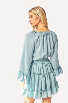 For a casual, stunning look turn to this flared mini dress, crafted with a light woven peasant fabric. Featuring bell sleeves, a tiered ruffled skirt, and an elastic waistline. -V neckline with ties.-Long bell sleeves.-Elastic waistline.-Ruffled, tiered skirt.-Lined.-60% Cotton 40% Poly.-By Mustard Seed USA. Size Guide -The model is wearing a size Small.-Model Specs. HEIGHT 5'9" BUST 32" WAIST 24" HIPS 34" Shipping ﻿-Ships within 5 days in the US. Brunch Mini Dress With Ruffle Hem, Ruffled Mini Hem Dress For Brunch, Casual Ruffle Dress With Layered Tiered Skirt, Casual Ruffle Dress With Layered Hem, Flowy Long Sleeve Tiered Dress With Ruffles, Flowy Ruffle Sleeve Tiered Vacation Dress, Flowy Tiered Dress With Ruffle Sleeves For Vacation, Flowy Tiered Dress With Ruffle Sleeves For Brunch, Brunch Tiered Dress With Ruffle Sleeves