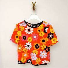 Victoria Beckham For Target Floral Crepe Blouse. Tie Back. Upper Keyhole. Short Sleeves. Relaxed Fit. Semi Cropped Silhouette. Round Trim Edges. Orange With Yellow, Pink, White & Black. Pretty Abstract Flowers. Size Xs Approximate Measurements... Pit To Pit Lying Flat: 17.5” Length: 21” Never Worn, No Flaws To Note. 70s 90s Disco Fun Vibrant Bold Smock Bright Pebble Hippie Bohemian Daisy Boho Pop Art 60s Aperol Spritz Clementine Tangerine Fairy Costume Cute Clown Frill Girly Throwback Retro Prin Orange Vibrant Print Short Sleeve Tops, Multicolor Floral Print Tops For Daywear, Vibrant Graphic Print Tops For Spring, Vintage Multicolor Tops For Day Out, Vibrant Floral Print Cotton Tops, Multicolor Summer Tops For Daywear, Vibrant Short Sleeve Spring Blouse, Vibrant Cotton Floral Print Top, Graphic Print Tops For Summer Daywear