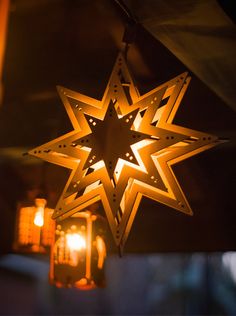 a lighted star hanging from the ceiling