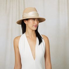 Sand toyo packable UPF 25+ protection fedora with cream shiny satin ruched band. UPF 25+ protection. Measurements: 6" X 3.75" X 3" SKU: 21005-250CS Fitted Cream Panama Hat With Short Brim, Elegant Adjustable Straw Hat With Upf 50+, Fitted Beige Wide Brim Fedora, Elegant Fitted Panama Hat For Travel, Elegant Fedora With Upf 50+ And Curved Brim, Kentucky Derby Fedora With Upf 50+ And Short Brim, Fitted Cream Panama Hat Fedora, Fitted Cream Fedora For Spring, Cream Panama Fedora Hat