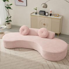 a pink couch sitting on top of a rug in a living room