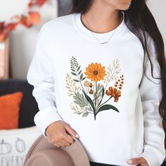 Introducing our delightful floral sweater, the perfect blend of style and comfort. Made from high-quality, soft materials, this sweater features a stunning floral design that adds a touch of elegance to any outfit. Whether you dress it up with a skirt or pair it with jeans for a casual day out, this versatile sweater will keep you cozy and chic all year long. With its flattering fit and eye-catching pattern, it's sure to become a favorite in your wardrobe. Step into the season with confidence and make a statement with our beautiful floral sweater. .: Made with a medium-heavy fabric blend of 50% cotton and 50% polyester (8.0 oz/yd² (271.25 g/m this sweatshirt feels cozy and is the perfect choice for those colder months. .: The classic fit along with the crew neckline deliver a comfy wearing Fall Cotton Sweater With Floral Print, Fall Cotton Floral Print Sweater, Cotton Floral Print Fall Sweater, Cotton Floral Print Sweater For Fall, White Tops With Plant Print For Fall, Floral Print Long Sleeve Sweatshirt For Fall, Fall Floral Print Crew Neck Sweater, White Floral Print Sweatshirt For Fall, Floral Print Crew Neck Sweater For Fall