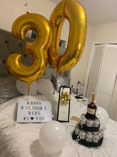 an image of a birthday party with balloons and gifts on the bed in the room