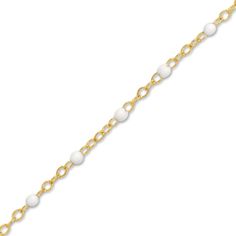 Distinctive white enamel beads embellish shimmering links around the length of this stylish women's bracelet. Fashioned in 14K yellow gold, the 7.5-inch cable chain secures in place with a spring ring clasp. Formal White Bracelets With Adjustable Chain, White Gold Beaded Bracelet As A Gift, Elegant White Chain Bracelet With Extender, White Beaded Gold Bracelet As Gift, White Pearl Bracelet With Lobster Clasp And Round Beads, White Pearl Bracelet With Lobster Clasp, White Bracelets With Adjustable Chain And Round Beads, Elegant White Beaded Chain Bracelet, White Pearl Bracelet With Beaded Chain