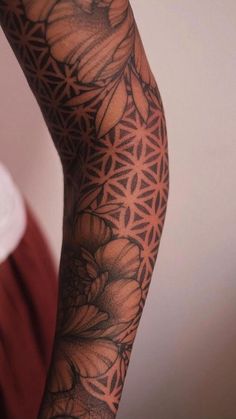 a person with tattoos on their arm and leg