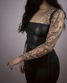 a woman with tattoos on her arm and shoulder