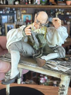 a man sitting on top of a wooden table