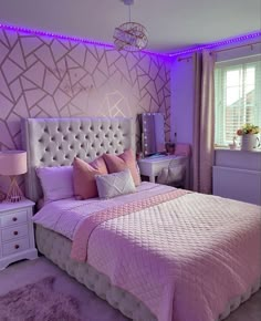 a bedroom decorated in pink and white with purple lighting on the walls, bedding and pillows