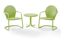 two green chairs and a table on a white background