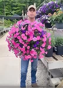 a man holding a large bouquet of flowers in his hands and looking at the camera