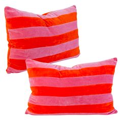 two red and pink pillows sitting next to each other