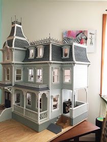 a large doll house sitting on top of a wooden table