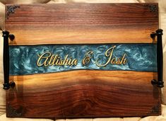 a wooden plaque with the name and date on it, sitting on top of a bed