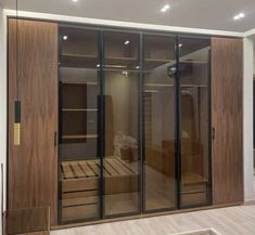 an empty room with wooden furniture and glass doors