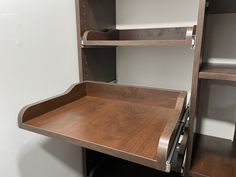 a wooden desk with drawers and shelves in a room