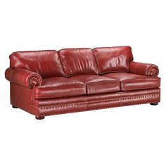 a red leather couch sitting on top of a white floor