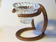 a glass vase sitting on top of a wooden stand