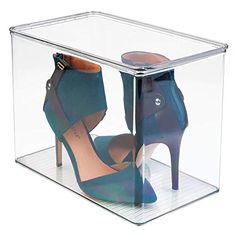 a pair of high heeled shoes in a clear box