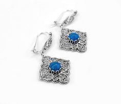 "Turquoise Corundum 925 Sterling Silver Flower Earrings Artisan Handcrafted Filigree Art Paisley Design Earrings Dangle Drop Earrings The length is 1.65\" and the width is 0.90\". The weight is 5.00 gr. Turquoise gemstone is natural and it is 6.00 mm round-shaped cabochon. Comes with velvet pouch and luxurious gift box. Filigree is made of delicate metal strands that have been skillfully fashioned to create an outstanding combination of old and modern art. Originating in Mesopotamia, Anatolia. I Elegant Turquoise Nickel-free Flower Earrings, Elegant Turquoise Flower Earrings Nickel Free, Sterling Silver Blue Earrings With Intricate Design, Blue Sterling Silver Earrings With Intricate Design, Blue Dangle Earrings With Intricate Design, Blue Intricate Design Drop Earrings, Blue Earrings With Intricate Design For Gift, Ornate Handmade Blue Earrings, Blue Ornate Handmade Earrings