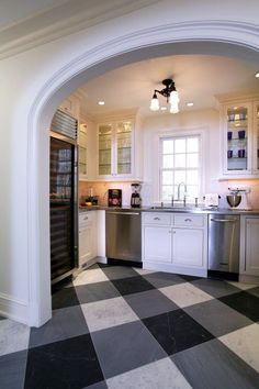 a kitchen with black and white checkered flooring