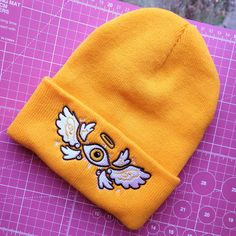 -𝘿𝙚𝙨𝙘𝙧𝙞𝙥𝙩𝙞𝙤𝙣- ❤ BE NOT AFRAID! Biblical Angel Beanies are here!! -𝙏𝙝𝙚 𝙎𝙩𝙤𝙧𝙮- Did you know Seraphims have six wings? One pair for flying, one for covering the face, and one for covering the feet! After creating the sticker design i felt like the design could have been so much more, And down the rabbit hole we went into beanie design. Seraphims, Oraphims, and a whole lot of back and forth later we have the first Beanie to the shop! Spread your wings with this Golden Seraphim Beanie. I hope you like it!! -𝙎𝙞𝙯𝙞𝙣𝙜 𝙖𝙣𝙙 𝙈𝙖𝙩𝙚𝙧𝙞𝙖𝙡𝙨- ❤ One size fits all ❤ High quality Acrylic and Embroidery  -𝙋𝙖𝙘𝙠𝙖𝙜𝙞𝙣𝙜- ❤ Beanie is packaged in a pink bubble mailer with love and care <3 -𝘿𝙚𝙡𝙞𝙫𝙚𝙧𝙮- FREE UK DELIVERY  Shipping is available worldwide! For US, Canada, Biblical Angel, Biblically Accurate Angel, Beanie Design, Angel Lovers, Be Not Afraid, Biblically Accurate, Down The Rabbit Hole, Artist Alley, Pink Bubbles