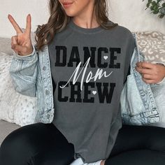 "Custom Dance Mom Crew Comfort Colors T-shirt, Trendy Name on Back Personalized Dance Mom Tee, Competition Dance Mom Unisex Sporty Shirt How To Order - Please make sure you have looked at all sizes and color charts. - Select from the various T-shirt sizes and colors from scroll-down menus. - Fill in the personalization box (if provided) as exemplified. - Click \"Add to cart\" button. You can turn back and add more items of different size and color. Order Process - Our processing time is 5-10 days. - Shipping is first class, usually 1-5 business days (after processing time) depending on the location. - You can choose faster shipping options at checkout. (This does not affect the production time, production time remains the same, expedited shipping is only for delivery time that will be unde Crew Neck T-shirt With Text Print For Dance Class, Casual Crew Neck T-shirt For Dance Class, Hip Hop T-shirt With Letter Print For Dance Class, Hip Hop Letter Print T-shirt For Dance Class, Cotton T-shirt With Letter Print For Dance Class, Graphic Tee For Dance Class With Short Sleeves, Graphic Tee T-shirt For Dance Class With Short Sleeves, Graphic Tee Short Sleeve T-shirt For Dance Class, Graphic Tee With Short Sleeves For Dance Class