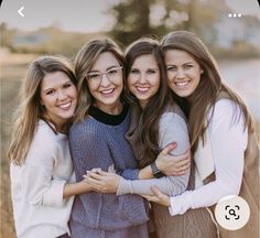 three girls hugging each other and smiling for the camera