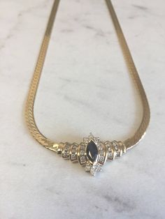 "An incredible 14kt Yellow Gold Lady's Diamond and Sapphire Necklace in 16\" consisting of 1- 8mm x 4m .75ct approx. total weight Genuine Marquise Sapphire with .50ct total weight of diamonds SI1/SI2 clarity, G color prong and channel set surrounding the gemstone with a flat 4mm Herringbone style chain with a heavy box clasp. This show stopper will lighten up any evening when worn. Sapphire is the Birthstone for September. The total weight of this Necklace is 14.5 grams. This item would Retail f Timeless Gold Necklace With Marquise Shape, Timeless Gold Marquise Necklace, Timeless Marquise Gold Necklace, Gold Marquise Diamond Necklace For Formal Events, Formal Marquise Necklaces With Diamond Accents, Elegant Formal 14k Stamped Diamond Necklace, Formal Marquise Necklace With Diamond Accents, Formal Marquise Gemstone Necklace, Timeless Gold Marquise Diamond Necklace