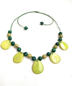 Taua Nut Necklace Necklace Length: 32 inches adjustable to shorter length Adjustable Round Beads Shell Necklace, Adjustable Yellow Necklaces With Wooden Beads, Adjustable Yellow Necklace With Wooden Beads, Adjustable Yellow Wooden Beads Necklace, Green Necklace With Adjustable Length For Gift, Adjustable Green Beaded Necklace, Adjustable 16-inch Beaded Necklaces, Green Beaded Necklace With Adjustable Chain, Green Necklace With Adjustable Chain For Beach