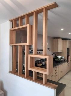 an open kitchen with wooden shelves on the wall