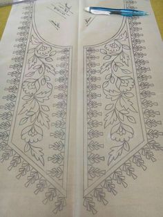 an embroidered piece of cloth with designs on it